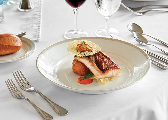 Expertly plated salmon entree from the American Cruise Lines culinary program
